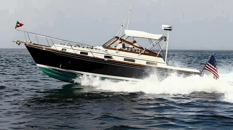  Yacht Photos Pics 1990 Little Harbor Express 36 yacht cruising on open water, displaying flags.