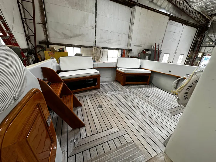  Yacht Photos Pics 1990 Little Harbor Express 36 yacht interior with wooden deck and cushioned seating.