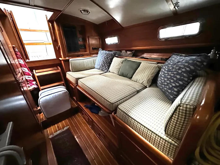  Yacht Photos Pics Cozy interior of 1990 Little Harbor Express 36 yacht with cushioned seating and wooden finishes.