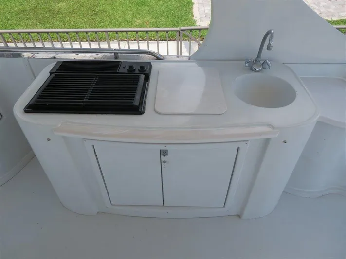  Yacht Photos Pics Outdoor kitchenette on 2000 Bluewater Yachts Millennium Series 63, featuring grill and sink.
