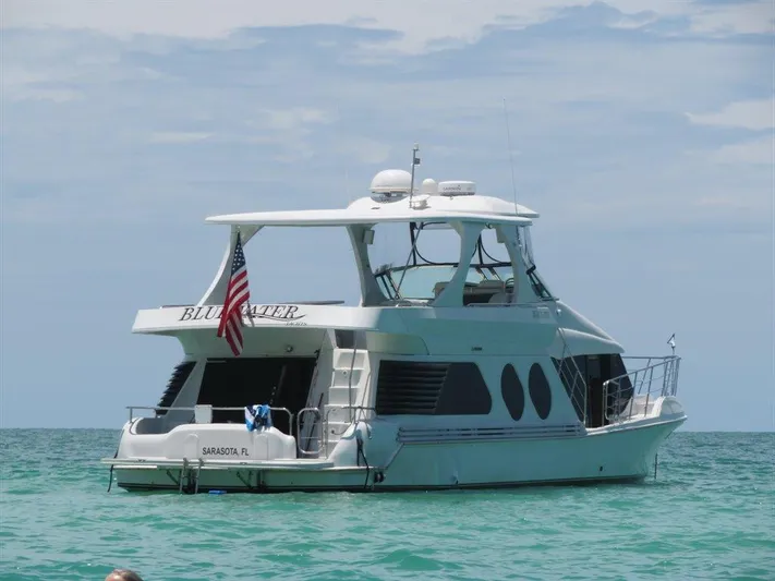  Yacht Photos Pics Bluewater Yachts Millennium Series 63, 2000 model, anchored in clear ocean waters.