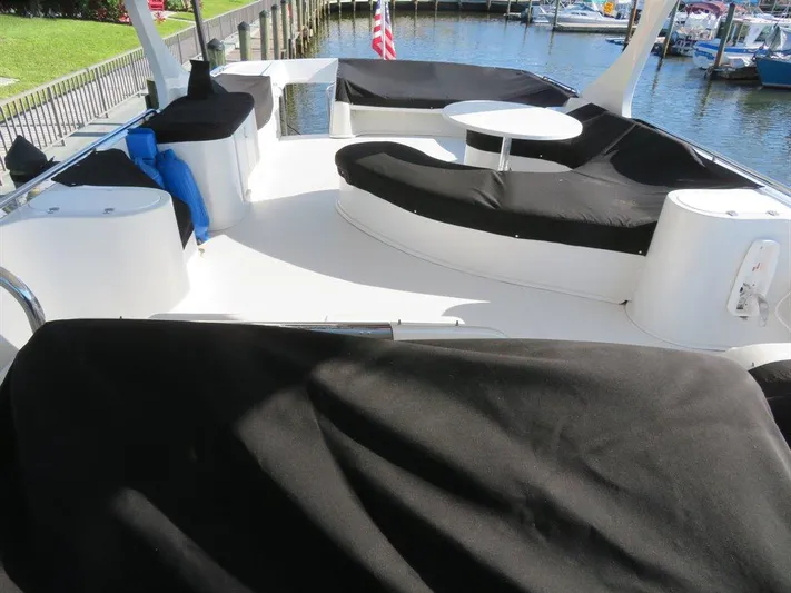  Yacht Photos Pics Spacious deck of 2000 Bluewater Yachts Millennium Series 63 with black seating covers.