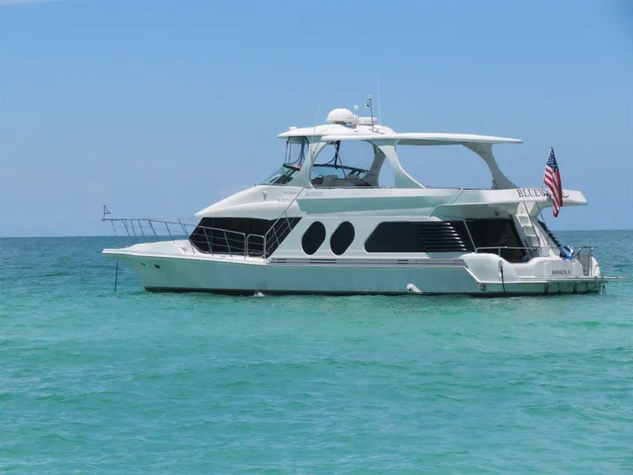  Yacht Photos Pics Bluewater Yachts Millennium Series 63, 2000 model, anchored in clear blue ocean waters.