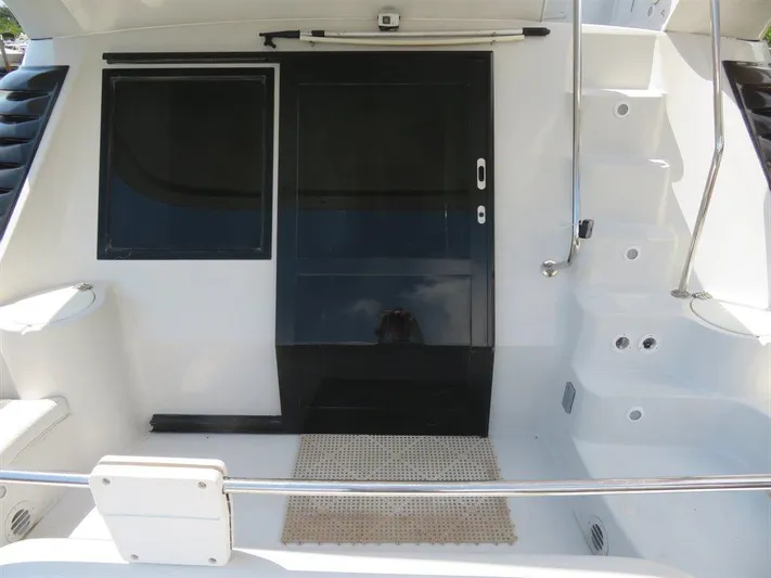  Yacht Photos Pics 2000 Bluewater Yachts Millennium Series 63 yacht deck with stairs and sliding door.