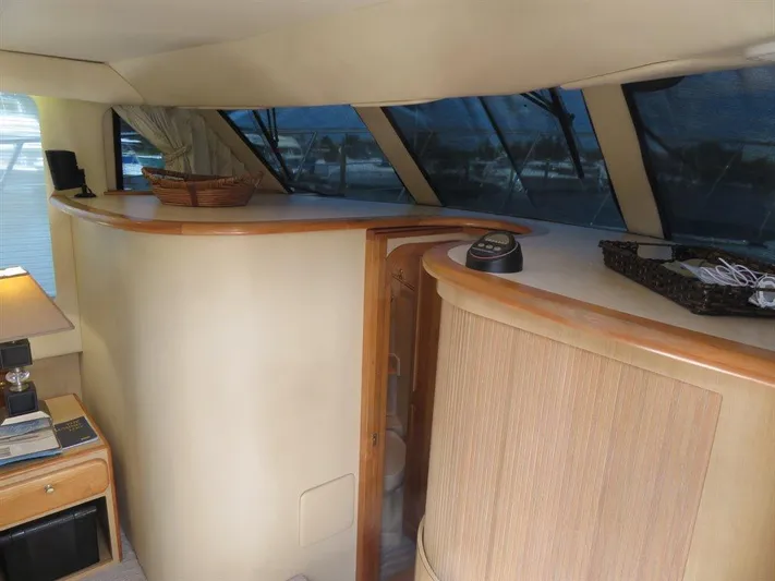  Yacht Photos Pics Interior of 2000 Bluewater Yachts Millennium Series 63, featuring wood accents and large windows.
