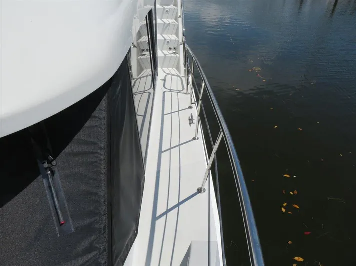  Yacht Photos Pics Side deck view of 2000 Bluewater Yachts Millennium Series 63 on calm water.