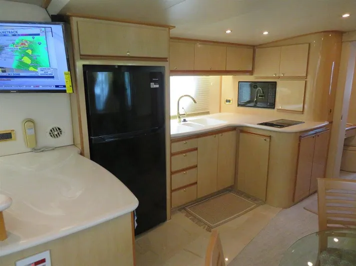  Yacht Photos Pics Luxurious kitchen in 2000 Bluewater Yachts Millennium Series 63 with modern appliances and sleek cabinetry.