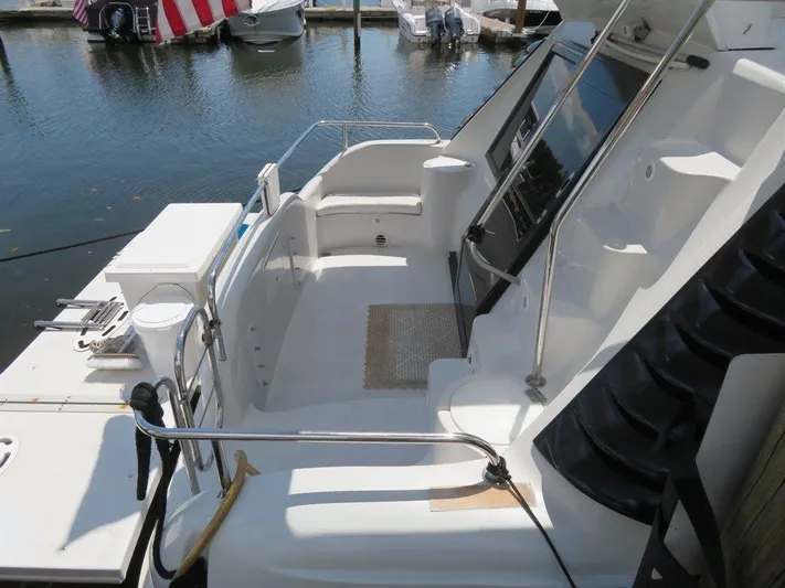  Yacht Photos Pics 2000 Bluewater Yachts Millennium Series 63, sleek deck design, docked at marina.