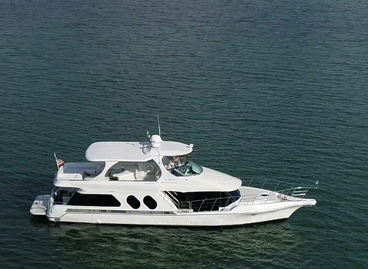  Yacht Photos Pics 2000 Bluewater Yachts Millennium Series 63 cruising on calm waters.