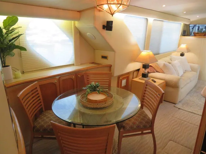  Yacht Photos Pics Luxurious interior of 2000 Bluewater Yachts Millennium Series 63 with dining area and cozy seating.
