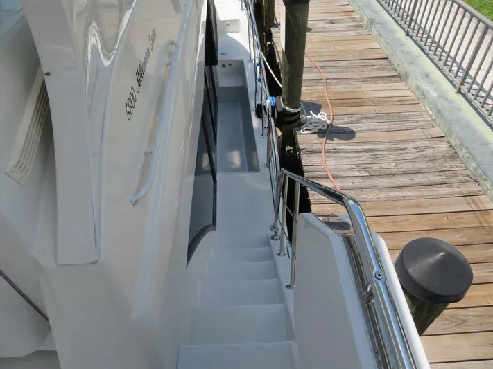  Yacht Photos Pics Stairway on 2000 Bluewater Yachts Millennium Series 63, docked beside wooden pier.