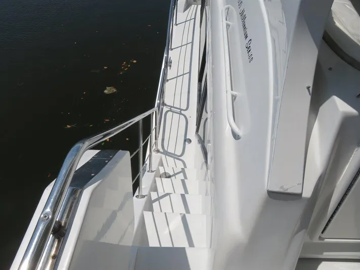  Yacht Photos Pics Staircase on 2000 Bluewater Yachts Millennium Series 63, with sleek white design and railing.