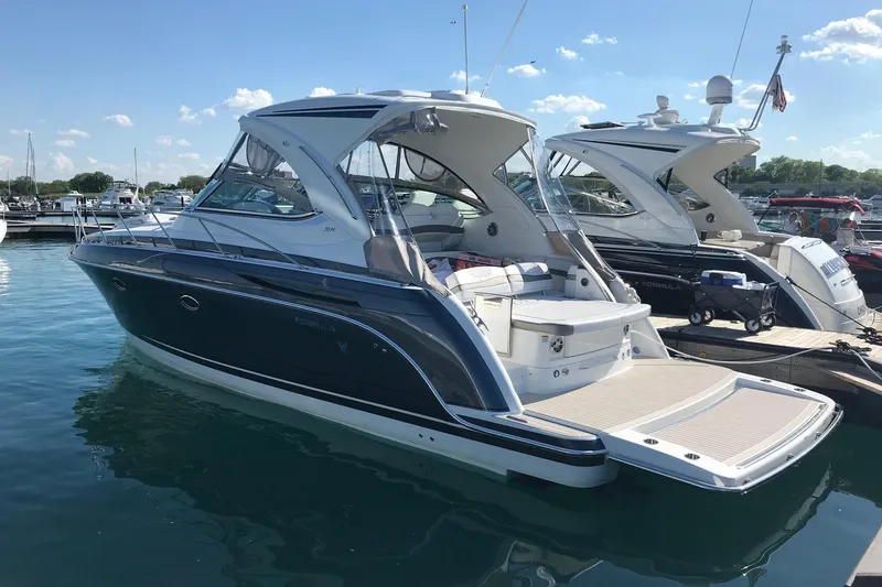Knot To Scale Yacht Photos Pics 2018 Formula 37 Performance Cruiser docked in a marina under a clear blue sky.