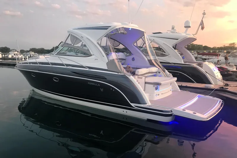 Knot To Scale Yacht Photos Pics 2018 Formula 37 Performance Cruiser docked at sunset, featuring sleek design and modern amenities.