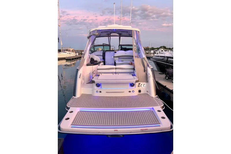 Knot To Scale Yacht Photos Pics 2018 Formula 37 Performance Cruiser docked at sunset, featuring spacious deck and modern design.