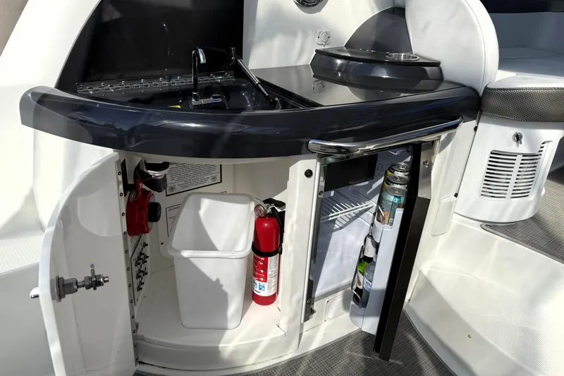 Knot To Scale Yacht Photos Pics 2018 Formula 37 Performance Cruiser kitchenette with sink, mini fridge, and storage.