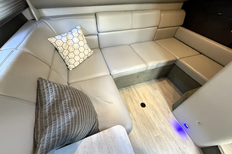 Knot To Scale Yacht Photos Pics 2018 Formula 37 Performance Cruiser interior with beige leather seating and decorative pillows.