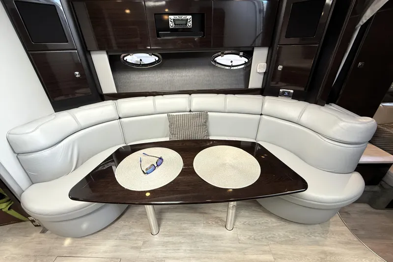 Knot To Scale Yacht Photos Pics Luxurious interior of 2018 Formula 37 Performance Cruiser with curved seating and elegant table.