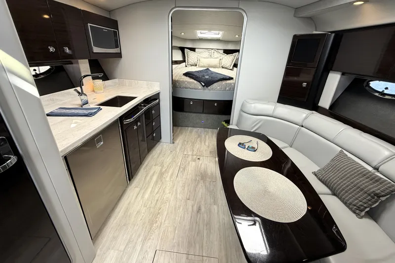 Knot To Scale Yacht Photos Pics 2018 Formula 37 Performance Cruiser interior with modern kitchen and cozy seating area.