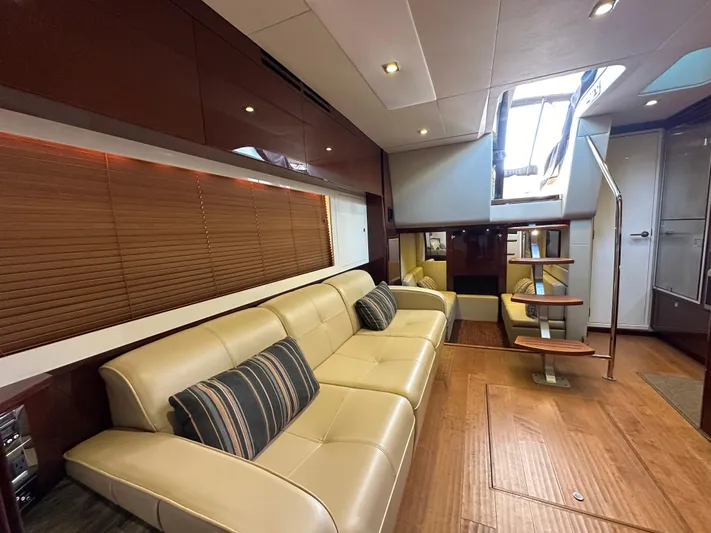 Divine Intervention Yacht Photos Pics Luxurious interior of 2015 Sea Ray 410 Sundancer yacht with beige leather seating.