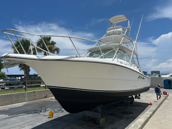 Ironman Yacht Photos Pics 2006 Rampage EXPRESS boat on dry dock under clear blue sky.