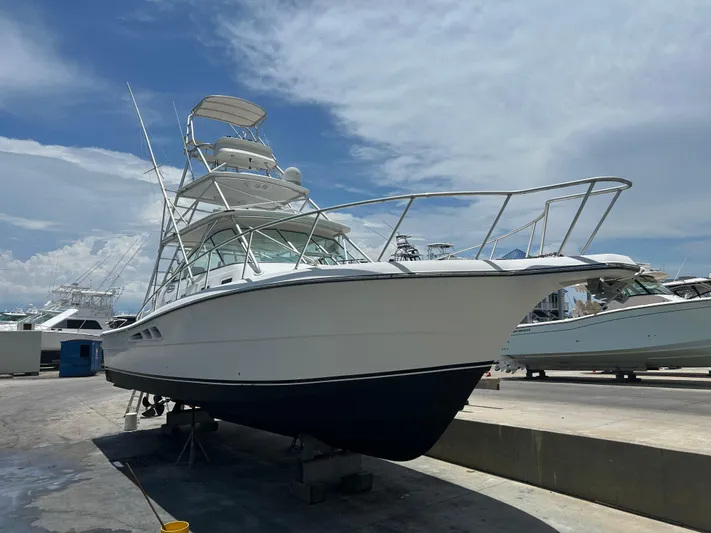 Ironman Yacht Photos Pics 2006 Rampage EXPRESS boat on dry dock under a clear sky.