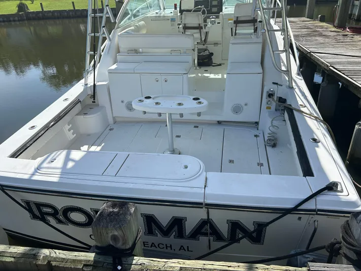 Ironman Yacht Photos Pics 2006 Rampage EXPRESS boat docked, featuring spacious deck and seating area.