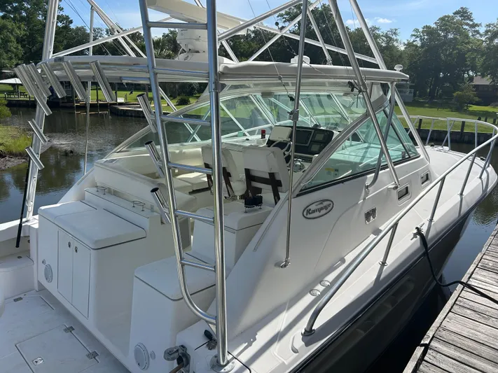 Ironman Yacht Photos Pics 2006 Rampage EXPRESS boat docked, featuring sleek design and spacious cockpit.