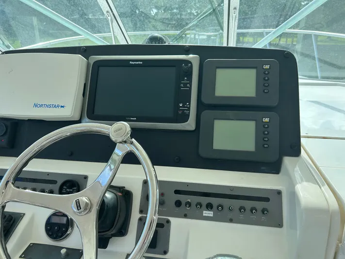 Ironman Yacht Photos Pics 2006 Rampage EXPRESS boat dashboard with steering wheel and navigation equipment.