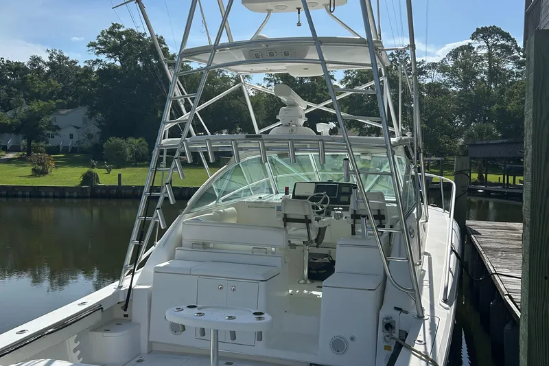 Ironman Yacht Photos Pics 2006 Rampage EXPRESS boat docked, featuring a spacious cockpit and fishing tower.