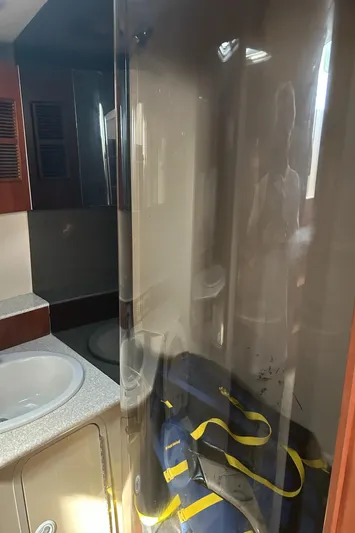 Ironman Yacht Photos Pics 2006 Rampage EXPRESS bathroom with sink, mirror, and storage cabinet.