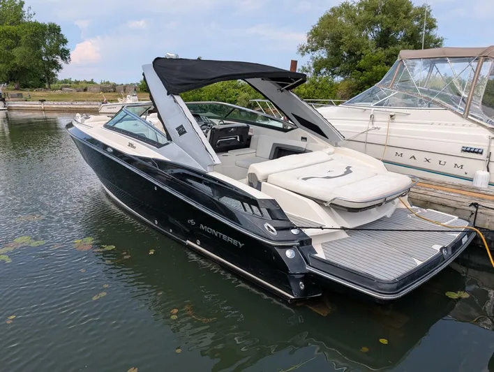  Yacht Photos Pics 2011 Monterey 328 SS boat docked in a serene marina setting.