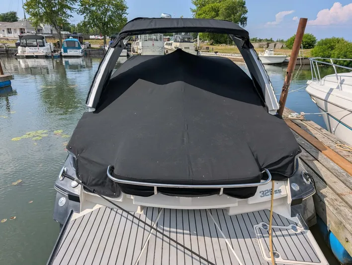  Yacht Photos Pics 2011 Monterey 328 SS boat docked with black cover, surrounded by water and other boats.