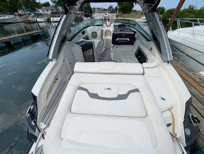  Yacht Photos Pics 2011 Monterey 328 SS boat interior with seating and dashboard, docked at marina.