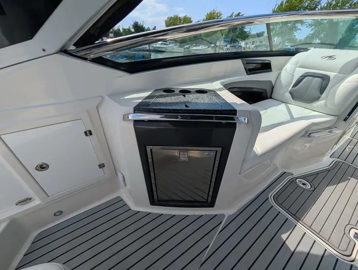  Yacht Photos Pics Interior of a 2011 Monterey 328 SS boat with seating and built-in cooler.