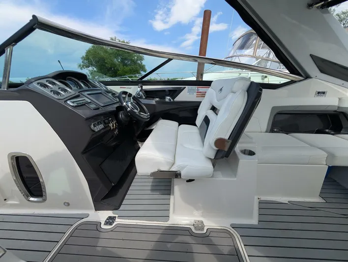  Yacht Photos Pics 2011 Monterey 328 SS boat interior with white seating and modern dashboard.