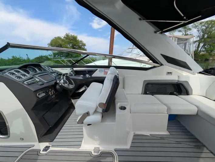  Yacht Photos Pics 2011 Monterey 328 SS boat interior with sleek dashboard and white seating.