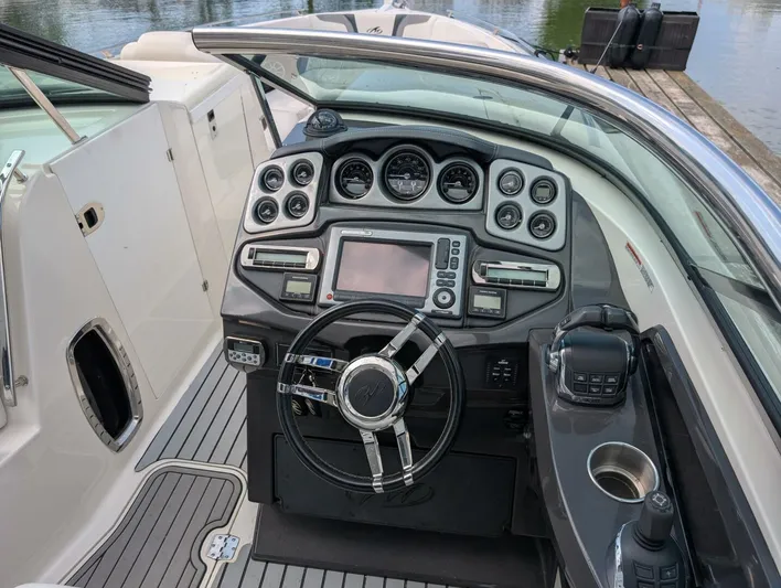  Yacht Photos Pics 2011 Monterey 328 SS boat dashboard with steering wheel and control panel.