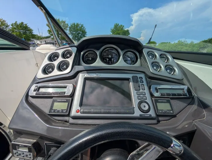  Yacht Photos Pics Dashboard of a 2011 Monterey 328 SS boat with gauges and navigation system.
