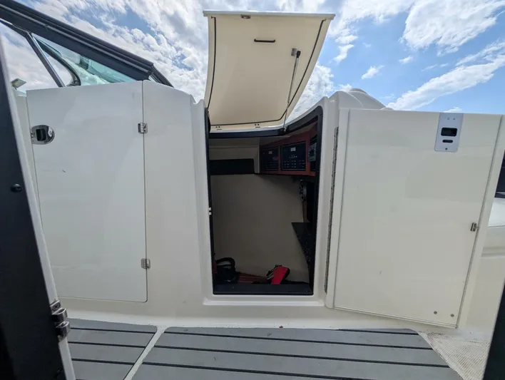 Yacht Photos Pics 2011 Monterey 328 SS boat cabin entrance with open doors under a cloudy sky.
