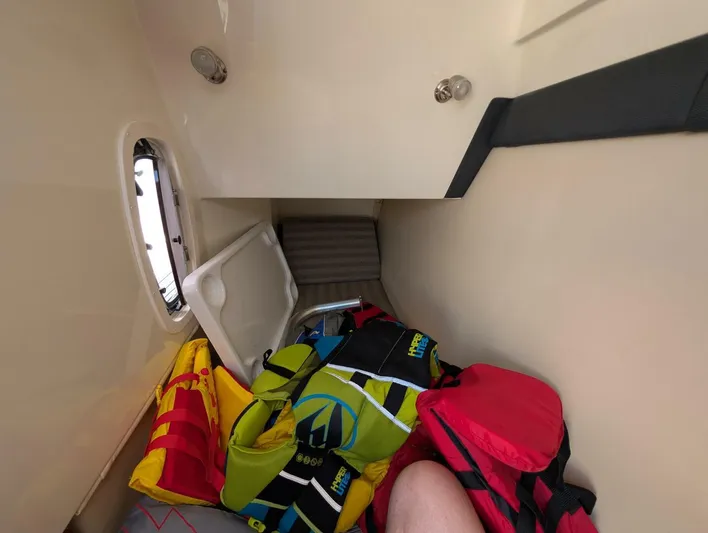  Yacht Photos Pics Interior cabin of 2011 Monterey 328 SS boat with colorful bags and life jackets.