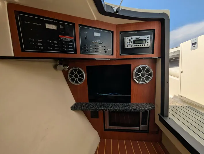  Yacht Photos Pics Interior control panel of a 2011 Monterey 328 SS boat with audio system and speakers.