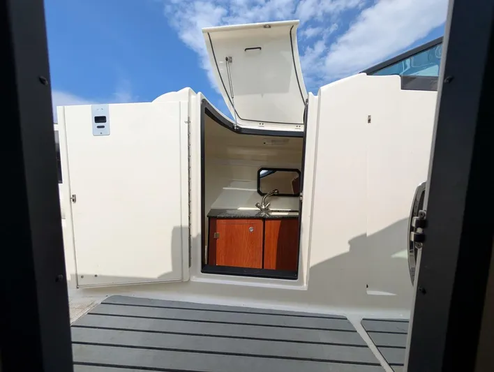  Yacht Photos Pics 2011 Monterey 328 SS boat interior with open hatch and compact kitchenette.