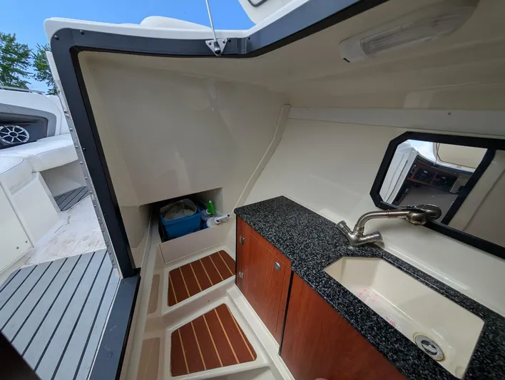  Yacht Photos Pics Interior of a 2011 Monterey 328 SS boat featuring a compact sink and storage area.