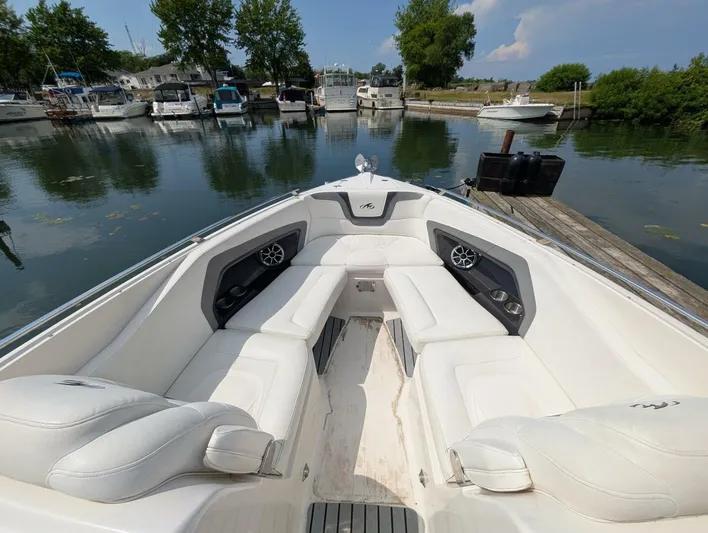  Yacht Photos Pics 2011 Monterey 328 SS boat interior with white seating, docked at a marina.