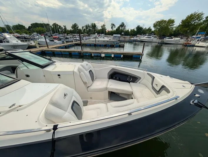  Yacht Photos Pics 2011 Monterey 328 SS boat with white seating, docked at a marina under cloudy skies.