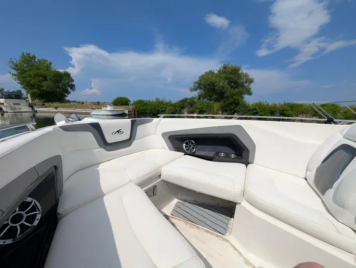  Yacht Photos Pics 2011 Monterey 328 SS boat interior with white seating, speakers, and blue sky background.