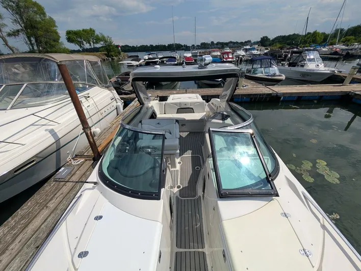  Yacht Photos Pics 2011 Monterey 328 SS boat docked at marina, surrounded by other boats.