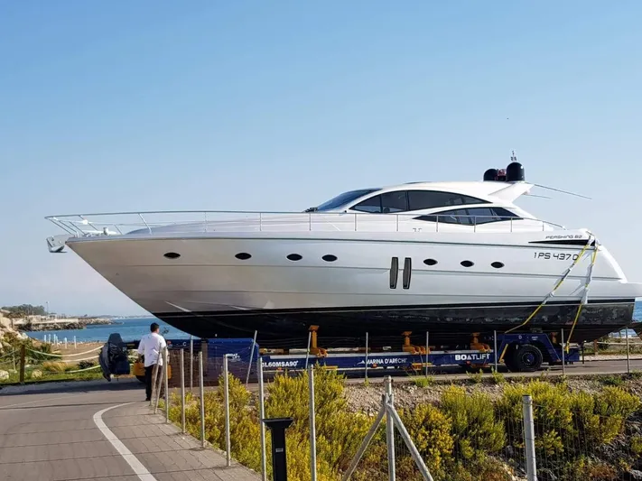 Uml Yacht Photos Pics 2007 Pershing 62' yacht on trailer near coastline, clear sky background.