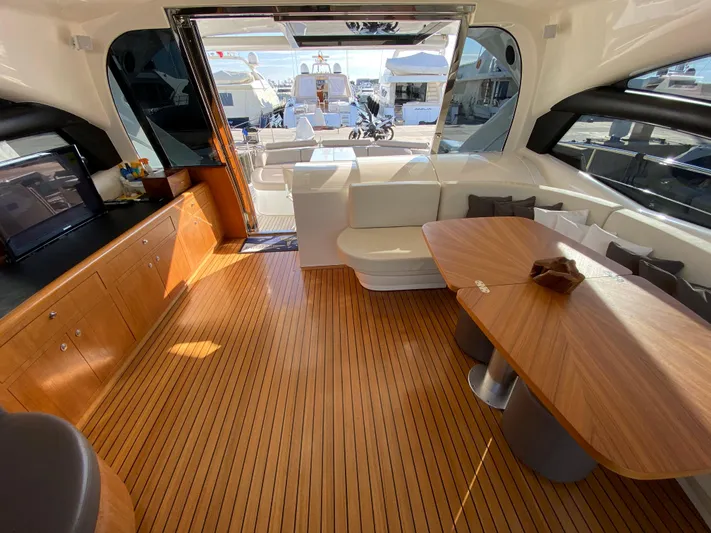 Uml Yacht Photos Pics Luxurious interior of a 2007 Pershing 62' yacht with wooden flooring and elegant seating.